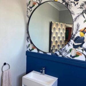 Round steel-framed mirror